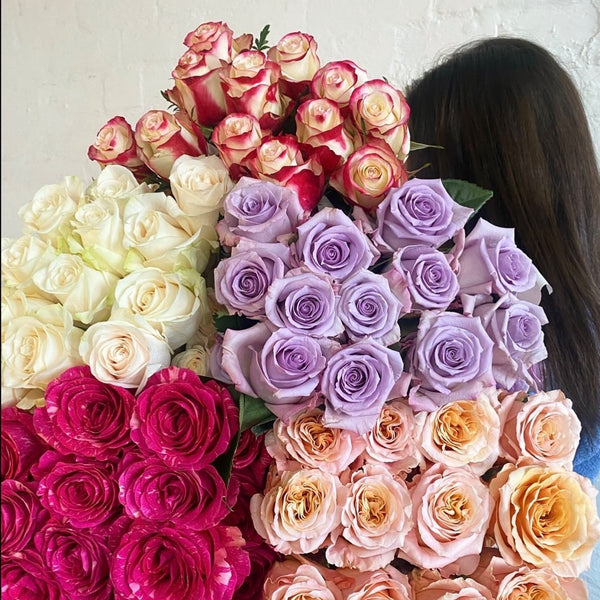 Colourful wholeslae roses held by girl